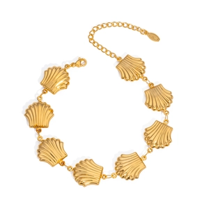 Detail of golden seashell link bracelet with ribbed texture and S.STEEL logo tag