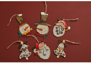 Detailed view of hand-painted wooden snowman and Santa hanging ornaments on red background