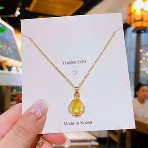 Golden titanium steel necklace featuring a yellow teardrop gemstone perfume bottle pendant