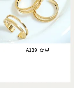 Close-up of minimalist gold layered double-U interlocking rings on white ceramic background