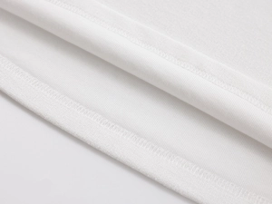 Macro view of white knitted fabric texture and precise double-needle stitching detail