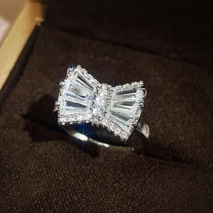 Macro shot of silver bow ring with shimmering cubic zirconia in a jewelry box