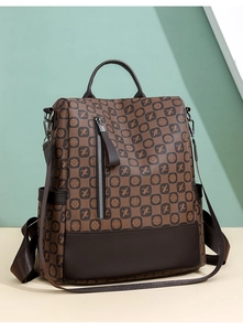 Detailed macro view of vintage print faux leather texture and metallic zipper of the backpack