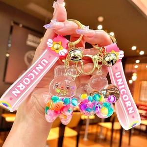Unicorn and rabbit liquid glitter keychain with pink silicone strap and golden bell