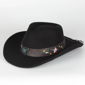 Detail of vintage black fedora with leather band, floral embroidery and metal bull skull