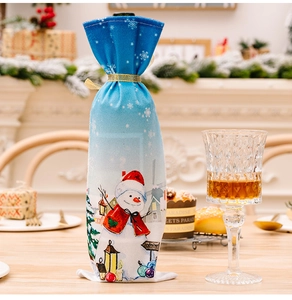 Detail of blue Christmas wine bottle cover with snowman illustration and gold ribbon