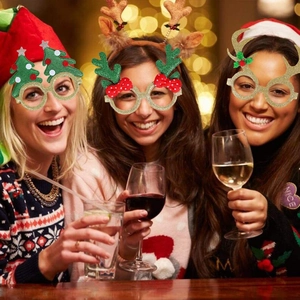 Women wearing sparkling Christmas glitter party glasses during a festive holiday celebration