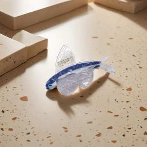 Blue and white acetate flying fish hair claw clip on stone minimalist background