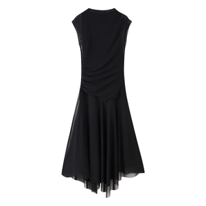Detailed close-up of ruched black sleeveless dress with irregular mesh hem and stretch fabric