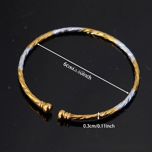 Macro shot showing 0.3cm thick gold and silver twisted rope bangle on black mirror surface