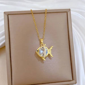 Gold goldfish pendant necklace with white zircons and blue eye on elegant jewelry box