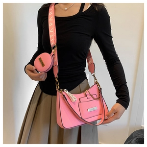 Detail of pink fashion handbag set with wide strap and matching round coin purse