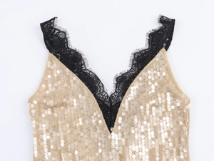 Detail of champagne gold sequins and black eyelash lace neckline on evening dress
