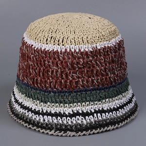 Close-up of bohemian multi-color striped handmade crochet straw bucket hat texture