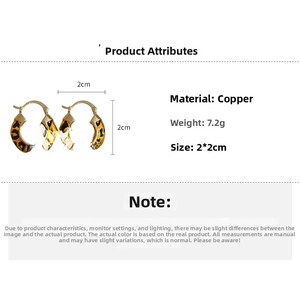 Detail view of 14k gold plated leopard print hoop earrings with dimensions and weight info