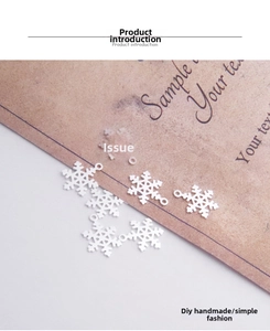Macro shot of white snowflake charm pendant for DIY handmade jewelry and bracelets