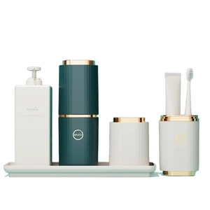 Portable dark green and cream travel wash set with soap dispenser and toothbrush holder