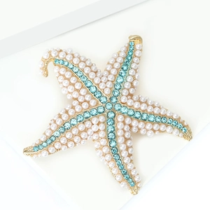 Detailed macro view of starfish brooch featuring white pearls and light blue rhinestones