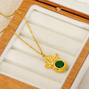 Retro golden cupid angel pendant necklace with green gemstone in a wooden jewelry box