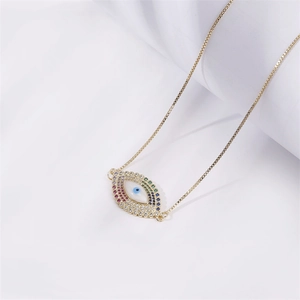 Gold evil eye necklace with colorful zircon stones on white background