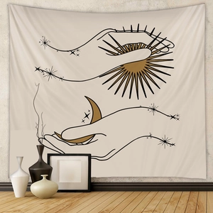 Detail of bohemian tapestry featuring hand-drawn sun and moon on a cream background