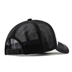 Detail of adjustable snapback closure and breathable mesh on black and white trucker hat
