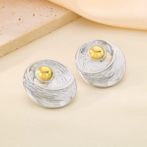 Detail of spiral texture earrings with mixed gold and silver tones in macro view