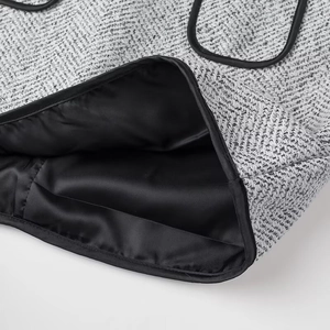 Detail of grey tweed bag with black satin lining and premium inner pocket stitching