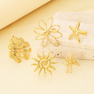 Detailed macro view of gold-tone rings featuring flower and starfish nature elements