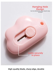 Close-up of pink cloud mini box cutter featuring the hanging hole and locking slider