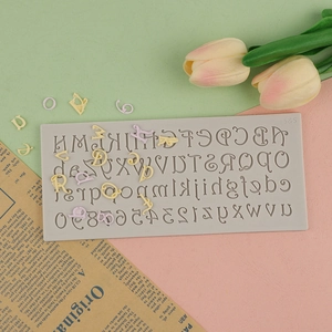 Macro shot of gray silicone mold with letters and numbers on pink and green background