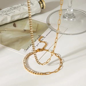 Detail showing the half-chain half-zircon gold necklace with a lobster clasp closure