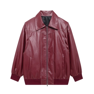 Close-up of wine red faux leather jacket with contrast white stitching and silver zipper