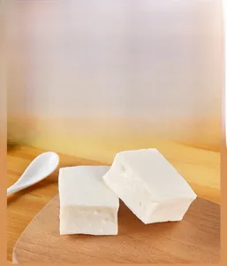 Detailed view of realistic PVC tofu food models with authentic texture on a wooden board