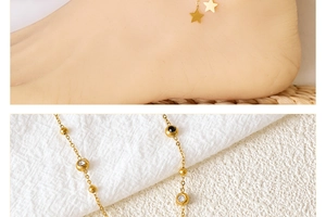 Detail of gold titanium steel anklet with star charm and zircon bead on ankle