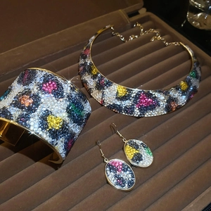 Detailed view of leopard print jewelry set with colorful rhinestones in a display box