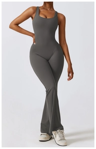 Detail of grey athletic jumpsuit showing high waist fit and stylish bell bottom legs