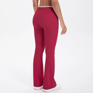 Detail of high-waisted burgundy flared yoga pants with white trim and matte elastic fabric