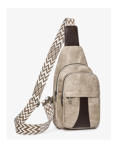 Detail view of beige crossbody chest bag with vintage texture and wide geometric strap