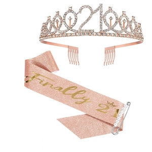 Detail of rose gold 21st birthday set with rhinestone tiara, glitter sash and pearl pin