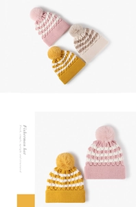 Detailed view of the thick knit texture and pom-pom decor on multi-colored beanies