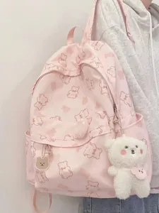 Pink cartoon bear backpack for girls featuring plush pendant and cute aesthetic prints