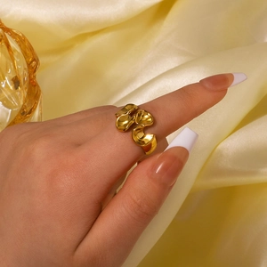Modern 18K gold plated stainless steel wave ring shown on model for a minimalist style