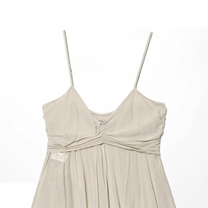 Elegant spaghetti strap dress with V-neckline and pleated detail in light sage green