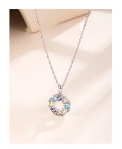 Macro detail of S925 silver necklace with circular pendant featuring colorful gemstones