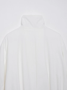 Detail of the high-quality stitching and cotton linen texture on the white jacket's back collar