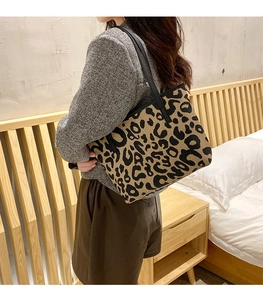 Chic leopard print canvas tote bag shown worn on the shoulder with casual autumn outfit