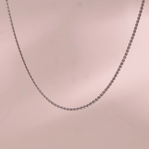 Detail of a high-quality silver rope chain necklace with a fine metallic texture