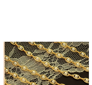 Close-up of a 18K gold plated chain necklace featuring elegant inlaid white pearls