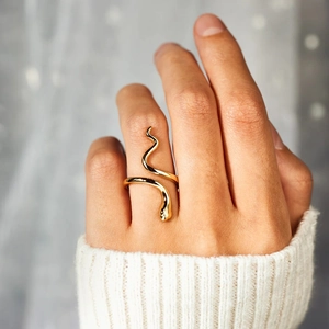 Elegant gold snake wrap ring in polished S925 sterling silver worn with white sweater